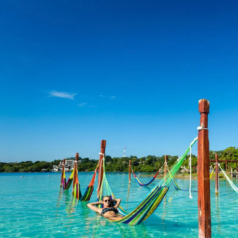 woman sitting in a floating hammock 1.jpg.webp